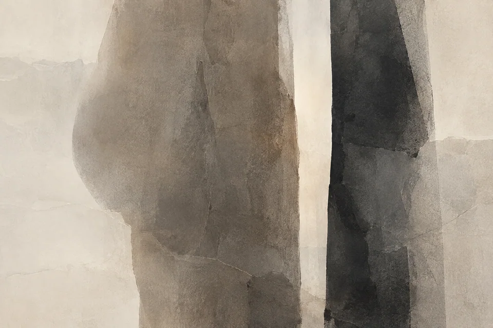Two charcoal and taupe forms frame a narrow, luminous interval.